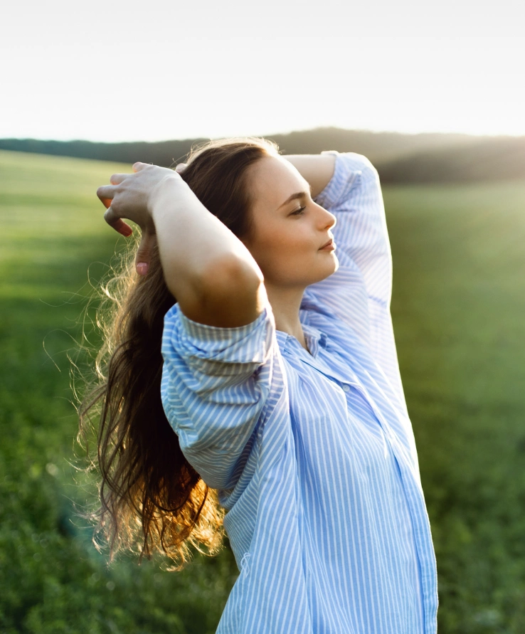 Woman relaxing peacefully in nature, representing emotional healing, inner peace, mindfulness, and spiritual wellness.